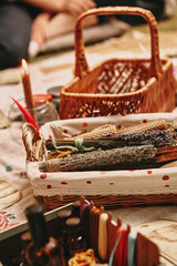 Hand made yellow candles from natural bee wax. Tdried grass and flowers are in the basket. Master class on creating candles