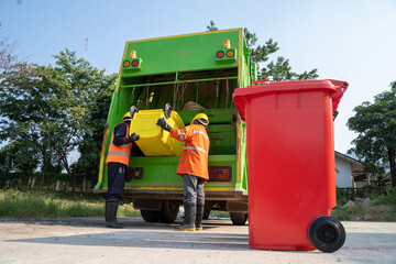 Garbage man working together on emptying dustbins for trash removal.