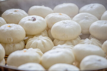Delicious baozi, thai steamed meat bun is ready to eat on serving plate and steamer