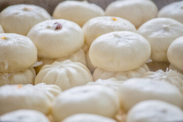 Fototapeta na wymiar Delicious baozi, thai steamed meat bun is ready to eat on serving plate and steamer