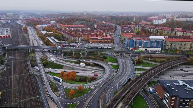 Aerial View Of Empty Train Tracks With E20 Extent Shared With E6 Road In Gothenburg Sweden. drone shot