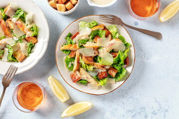 Chicken Caesar salad, shot from the top with lemons and wine, with a place for text