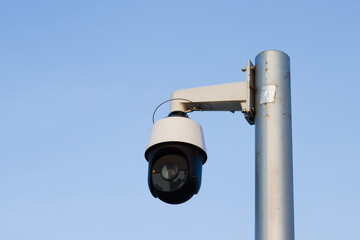 Security camera system against blue sky.