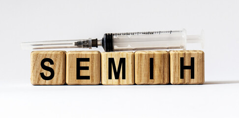 Text SEMIH made from wooden cubes. White background