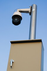 Security camera system against blue sky.