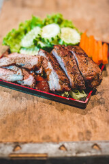 Smoked Barbecue Pork Spare Ribs with Sauce on a cutting board, selective focus
