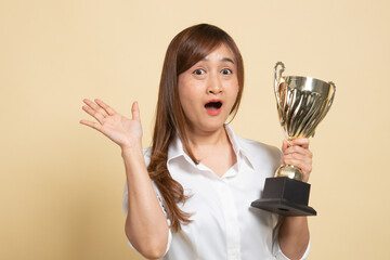 Successful young asian woman holding a trophy.