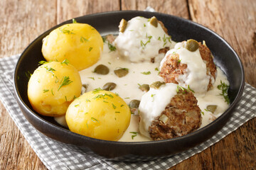 Authentic Konigsberger Klopse meatballs in caper sauce close-up in a plate. horizontal