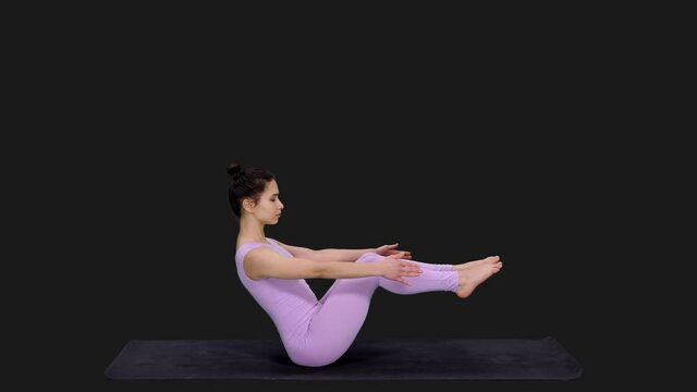 Young sporty woman doing boat pose during yoga, Full HD footage with alpha transparency channel isolated on black background