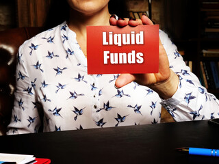 Woman showing blank red business card with written text Liquid Funds .