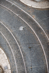 Lisbon cobblestone curved street aerial with tram tracks.