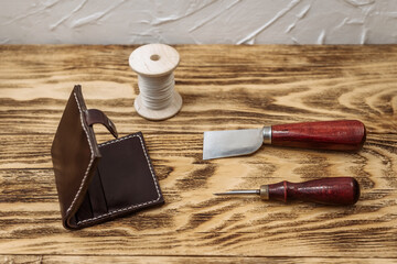 handmade genuine leather wallet and craftsman sewing tools. workshop on leather accessories.