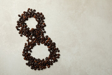 Eight made of coffee beans on white textured background