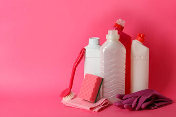 Group of different cleaning tools on pink background
