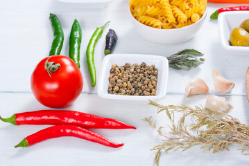traditional italian food ingredients on white wood table