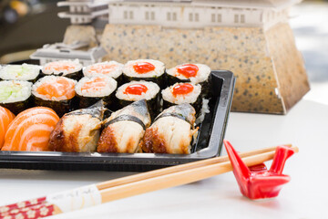 California an eel fish sushi rolls set on the stone plate, sushi delivery set
