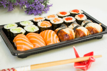 California an eel fish sushi rolls set on the stone plate, sushi delivery set