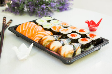 California an eel fish sushi rolls set on the stone plate, sushi delivery set