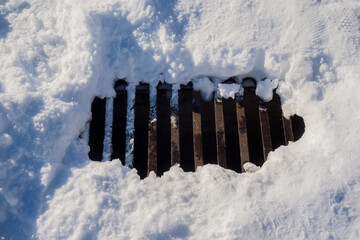 Sewer surrounded by snow on a cold winter's day.