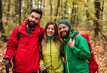 Happy active hikers in autumn forest