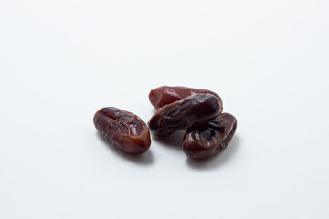 Dates on a white background. Dried fruits. Dried dates lie next to each other