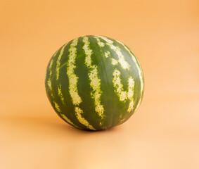 Whole watermelon isolated on orange background