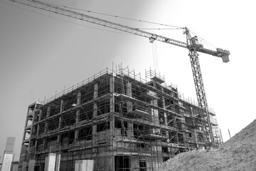 under construction building with tower crane