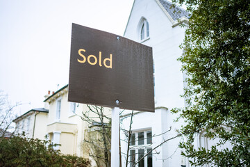 Estate Agent  'Sold' sign on urban UK street