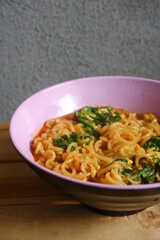 a bowl of noodle cooked with vegetables 