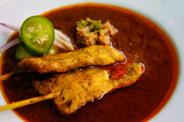 grilled pork satay with peanut sauce and vinegar on table