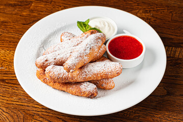 deep fried donuts with berry sauce