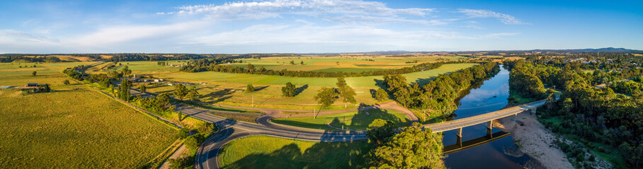Fototapeta na wymiar Wide aerial panorama of Princes Highway passing through Australian countryside at sunset