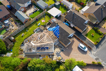 Obraz premium Aerial photo of a typical british housing esate in the Village of Kippax in Leeds West Yorkshire, suburban housing estates and road in the village showing an extension being built on a property