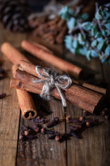 Bunch of cinnamon sticks on wooden background.
