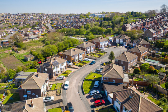 Aerial photo of the town of Kippax in Leeds West Yorkshire in the UK showing residential housing estates on a beautiful sunny summers day with white fluffy clouds in the sky.