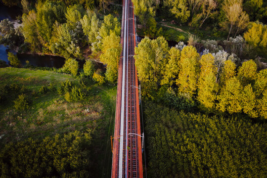 Aerial view of train rail road crossing the countryside near Flaca township, Girona, Spain.