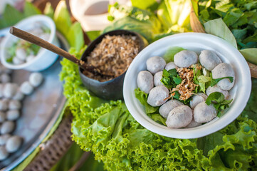 Meatballs stewed with vegetables on complex background