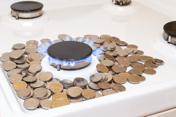 Money and gas burner on a white background with space for text. The cost, price of natural gas in the world