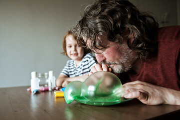 Father and son make slime at home. Homemade experiments.
