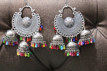 Pair of black metal earring on Black Background