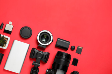 Flat lay composition with camera and video production equipment on red background. Space for text