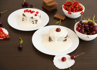 Sweet dessert. Chocolate cookies with a sweet vanilla sauce and fresh cherries, red currant berries

