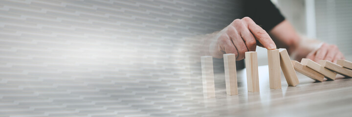 Concept of business control by stopping domino effect; panoramic banner