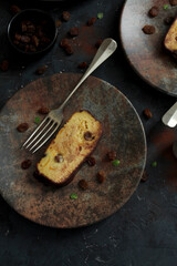 Bakery panettone pudding cake with raisins and chocolate on dark background. Top view with copy space.