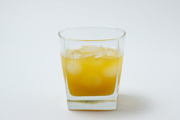 Fototapeta na wymiar Juice with ice in a glass on a white background. Natural mango juice. Refreshing drink