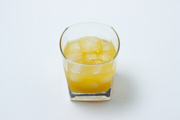 Juice with ice in a glass on a white background. Natural mango juice. Refreshing drink
