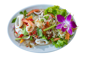 Spicy salad is popular Thai food. Mix seafood with spicy sauce, chilies, mangoes and spicy herbs. Selective focus, shoot in studio, Clean food concept.