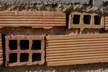 Old dirty orange bricks in a broken wall