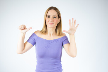 Fototapeta premium Young woman over isolated white background happy and counting six with fingers