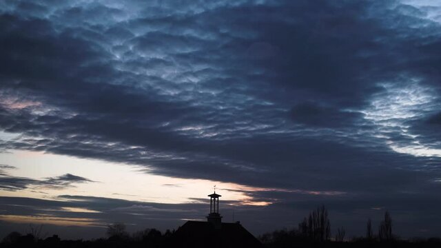 altocumulus navy blue cloud forming sunset sky time lapse silhouette clock tower